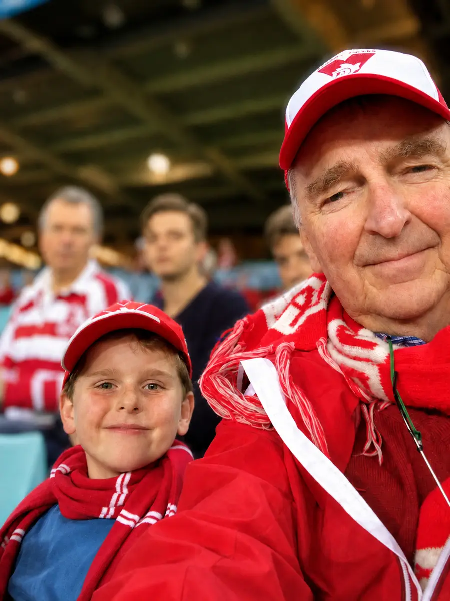 Malcolm McKinnon and his grandson Max at a Sydney Swans game