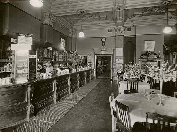 Interior of the Moss Vale Railway Refreshment Room in 1935, with a long counter and dining tables